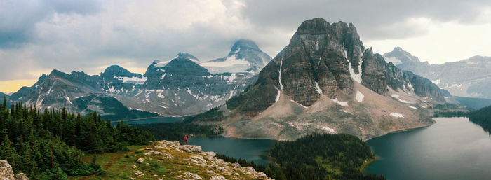 Panoramic shot of snowcapped mountains by lake against sky