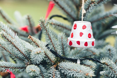 Handmade toy made of small flower pot on a christmas tree outdoor. diy decoration creative ideas for