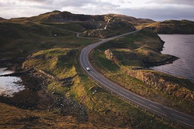 High angle view of car on road against cloudy sky