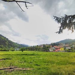 Scenic view of field against cloudy sky