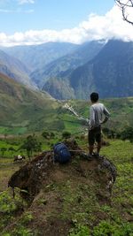 Rear view of man looking at mountains