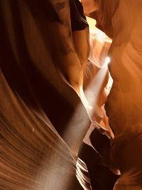 Low angle view of lit candles on wood