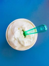 High angle view of ice cream against blue background