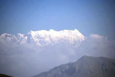 Low angle view of snowcapped mountain against sky