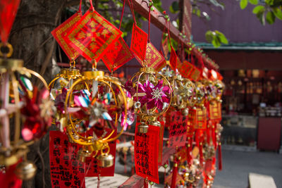 Close-up of religious equipment hanging outside temple
