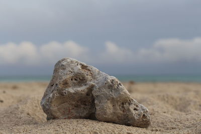 Rocks on beach against sky