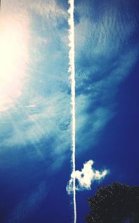 Low angle view of vapor trail against blue sky
