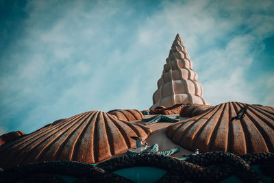 Low angle view of stack of roof against sky