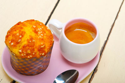 Coffee and muffin served on a pink heart shaped dish