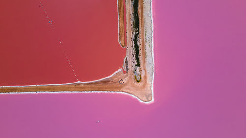 Close-up of old metal against pink background