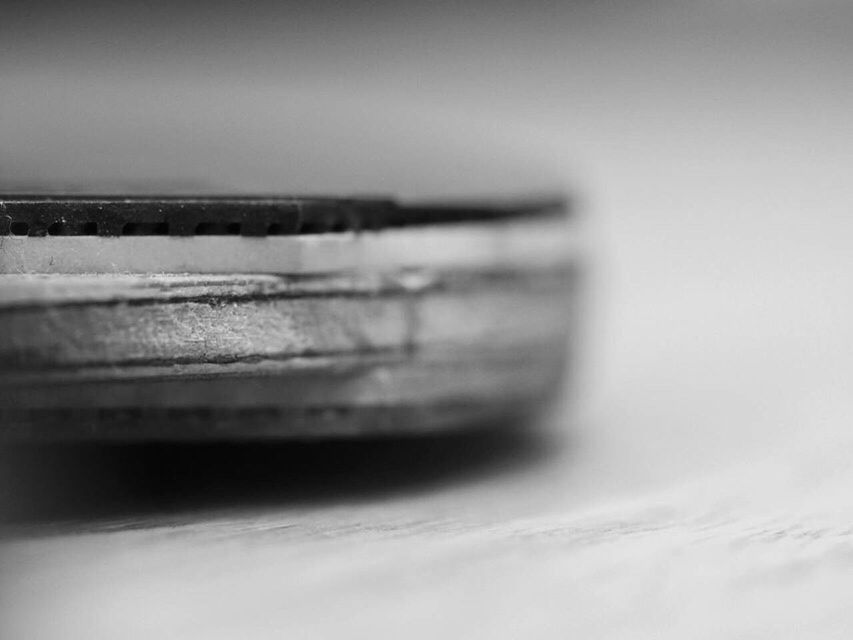 close-up, indoors, selective focus, copy space, still life, white background, studio shot, single object, focus on foreground, no people, white color, part of, detail, white, simplicity, reflection, cropped, metal, glass - material, table