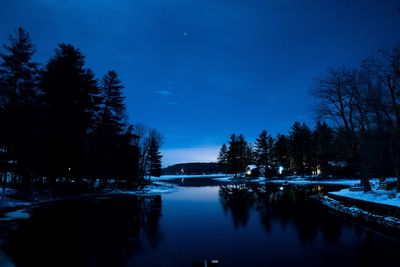 Scenic view of calm lake against sky at dusk during winter