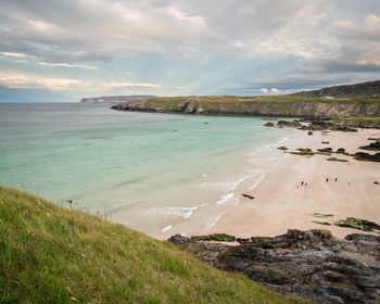 View of beach against cloudy sky