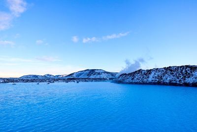Scenic view of lake against blue sky
