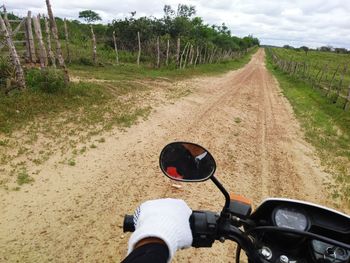 Man riding bicycle on dirt road