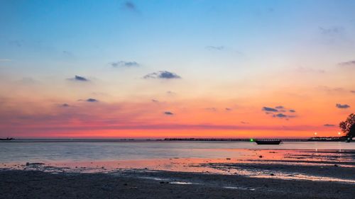 Scenic view of beach against sky during sunset