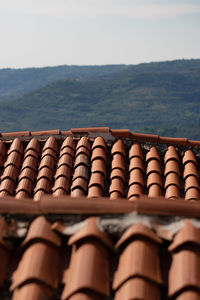 Close-up of railing on roof against sky