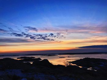 Scenic view of sea against sky at sunset