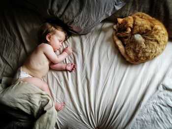 High angle view of baby sleeping on bed