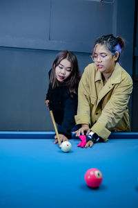 High angle view of woman playing pool