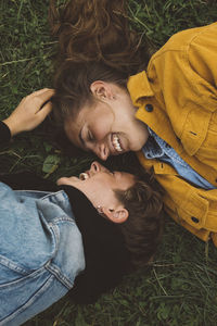 High angle view of friends relaxing on field