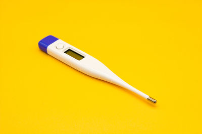 High angle view of pen on yellow background