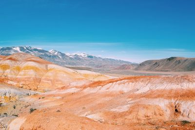 View of mountain range against blue sky