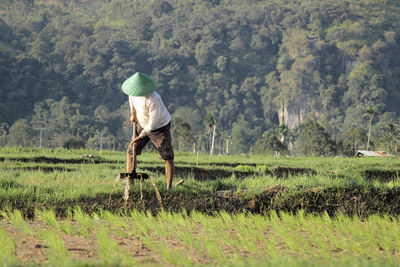 Side view of person working on field