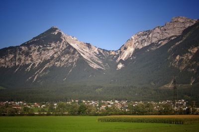 Scenic view of mountains against clear blue sky