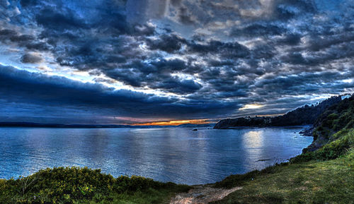 Scenic view of calm sea against cloudy sky