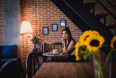 Woman sitting on table