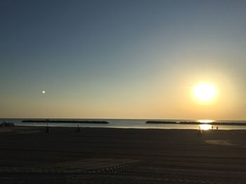 Scenic view of sea against clear sky during sunset