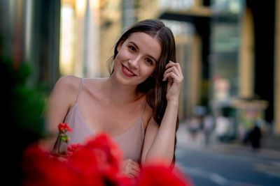 Portrait of smiling young woman in city