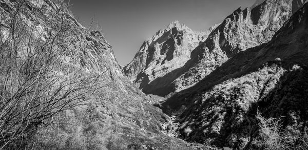 Low angle view of mountains against sky during winter