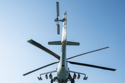 Helicopter gunship on a blue sky background