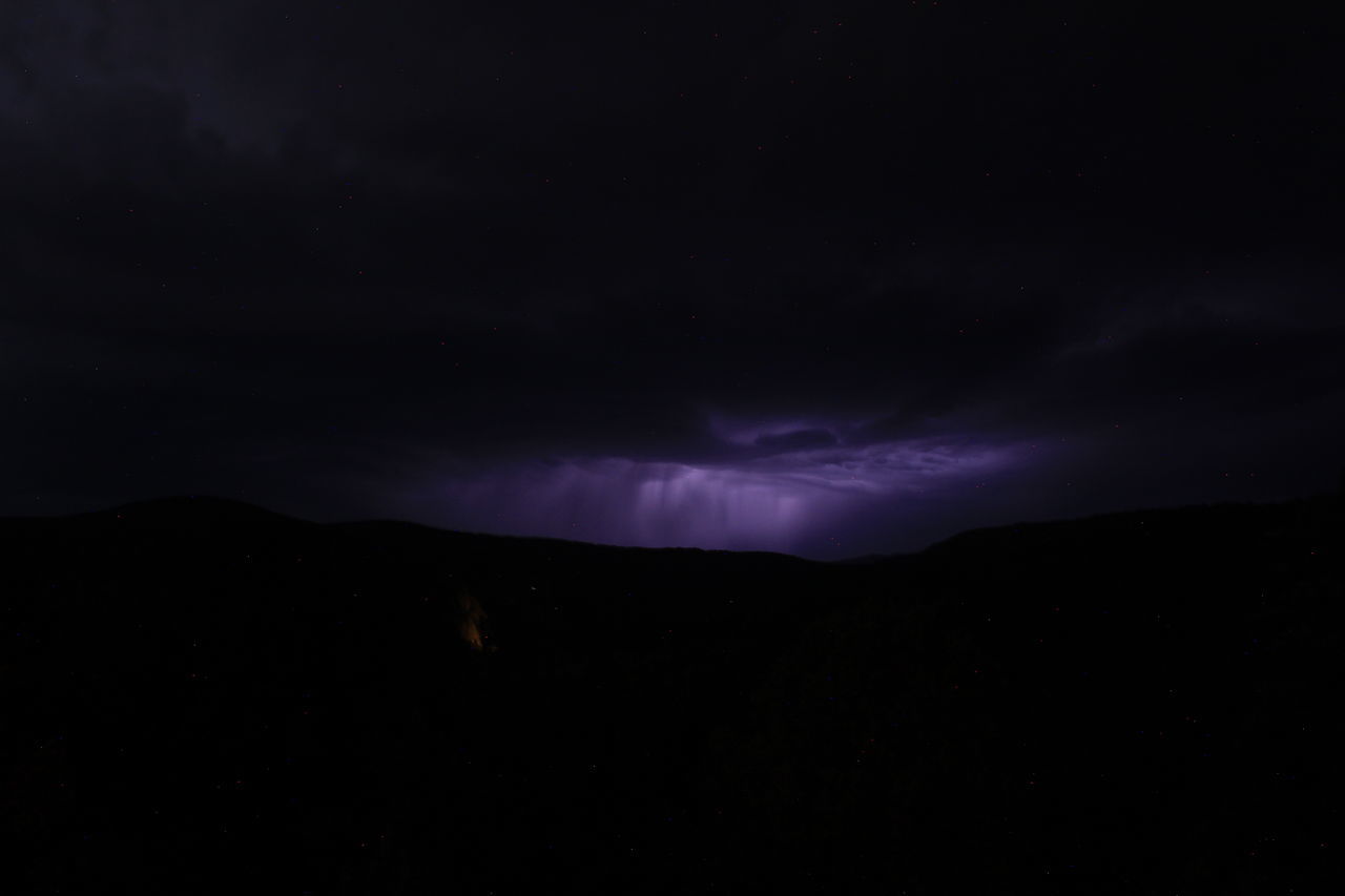 sky, beauty in nature, night, cloud, darkness, mountain, scenics - nature, lightning, power in nature, storm, environment, thunderstorm, no people, dramatic sky, nature, silhouette, dark, landscape, thunder, mountain range, storm cloud, awe, outdoors, star, warning sign