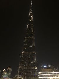 Low angle view of illuminated buildings against sky at night