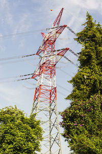 Low angle view of electricity pylon against sky