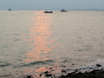 Boat sailing in sea against sky