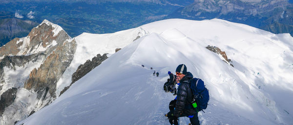 People skiing on snowcapped mountain