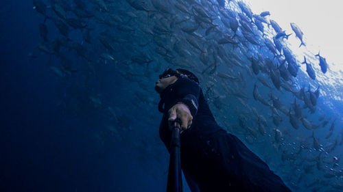 Low angle view of man swimming in sea