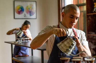 Man pouring tea at restaurant