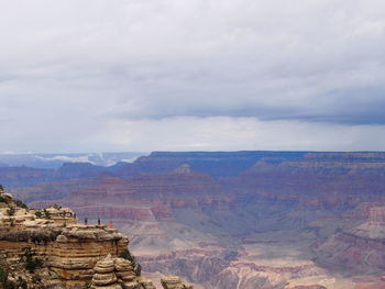 Scenic view of mountain range against cloudy sky