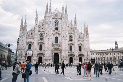 Group of people in front of building against sky