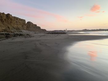 Scenic view of beach against sky during sunset