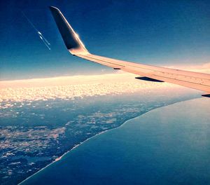 Aerial view of airplane wing over city