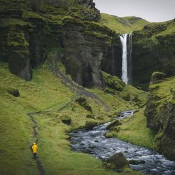 Scenic view of waterfall against sky