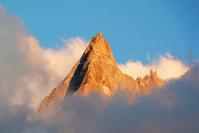 Low angle view of rock formation against sky