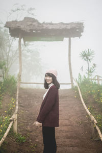 Side view of young woman standing on land