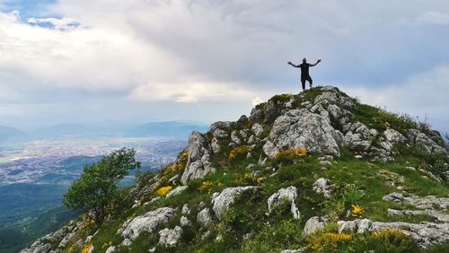 Man standing on mountain against sky